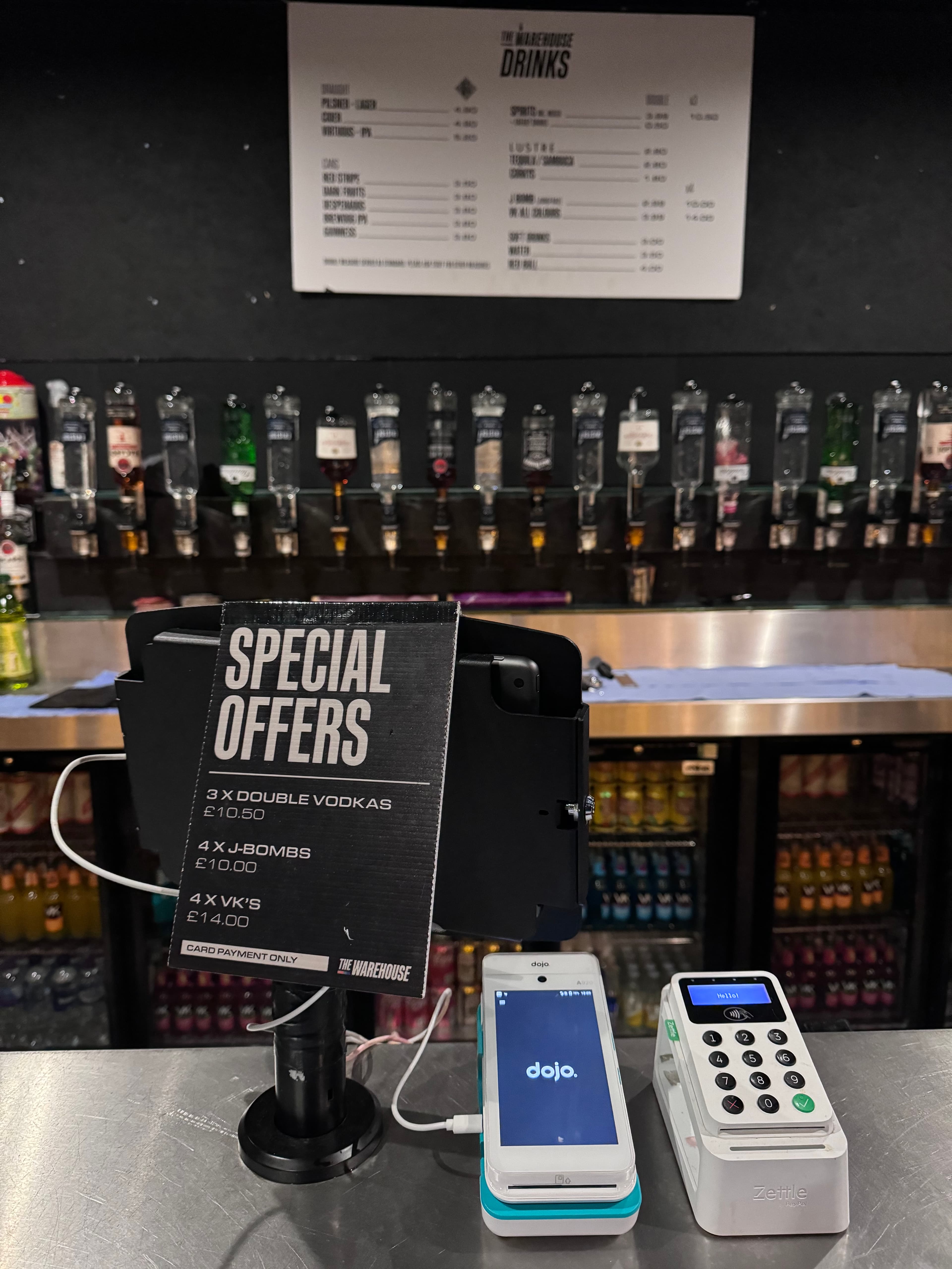 Dojo Go terminal next to a Zettle reader at a bar, real side-by-side comparison