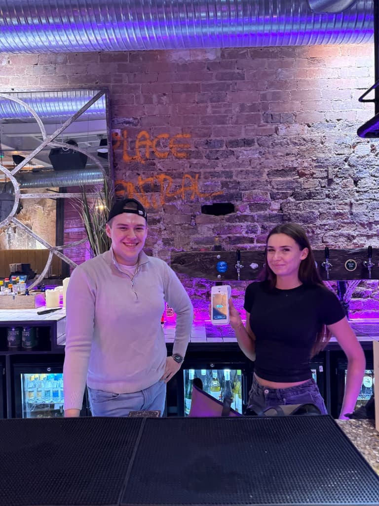 CapExpand team with bar staff holding a Dojo terminal at Green Room Leeds